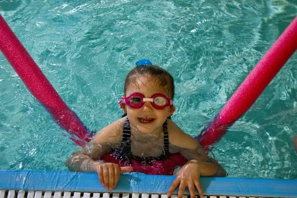 Child with goggles in swimming lesson