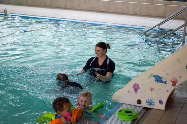 Swimming instructor with toddlers in pool at M Club Spa, Newcastle-under-Lyme